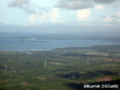 A view from Pinagbanderahan Peak of Pagbilao Bay with Patayan Island in the middle. To the right, the mouth of Tambak River may be seen merging with Pagbilao Bay. In the far right, Lucena City is barely seen. (see Patayan Island feature in www.pagbilao.org)
Photo by:: GBLontok (2006)