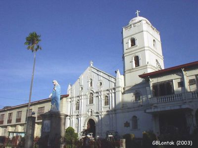 The St. Francis of Assisi Church facade is basked with the early morning sun. The Marian image in the foreground was once featured in a magazine TV show as miraculous after a mysterious change in the appearance of its eyes.
Photo by:: GBLontok (2003)