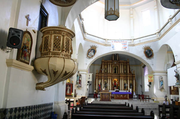 The present look inside the church dates back to the renovations since the post war period, among which are the refurbishing done on the Retablo, the replacement of more massive and long wooden benches, the attachment of platforms for additional Santos on the columns and the repainting of the walls. The hollowed out bottom center of the altar features the miraculous 18th century icon of Sariaya, the Santo Cristo de Burgos perpetually enshrined behind it. It is a replica of the holy medieval crucifix in Burgos, Spain accordingly petitioned from King Felipe V, and the subject of an every Friday pilgrimage to Sariaya by its fervent devotees from far and wide.
Photo by:: EPPGarcia (2009)